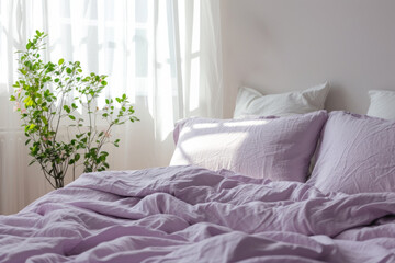Modern bedroom with pastel lavender bedding and a potted palm plant by the window casting a shadow...