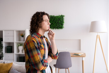 Photo of funny thoughtful guy dressed checkered shirt hand arm chin thinking indoors house home room