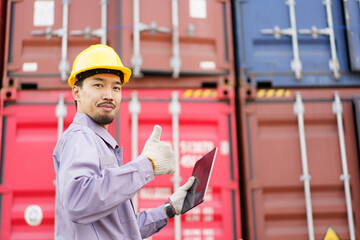 Asian male customs officer is currently conducting inspections of containers within the container...