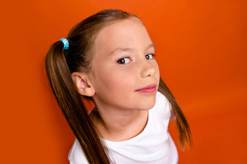 Photo of positive funky adorable girl interested eavesdrop listen news isolated on orange color background