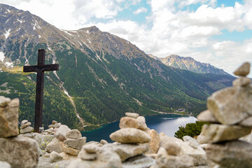 christian cross above the Morskie Oko mountain lake and hiking destination 