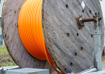 Cable reel on a construction site with an orange cable
