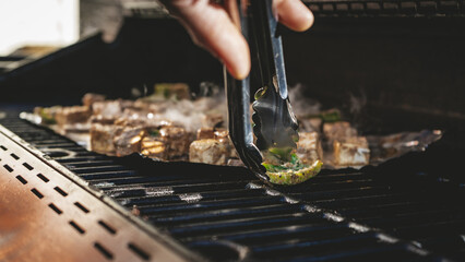 Paneer grilling on the barbecue, captured in a close-up shot with a shallow depth of field.