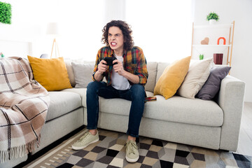 Full length photo of furious funny guy wear plaid shirt loosing playstation game indoors room home...