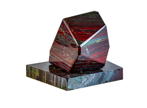 Polished jaspilite isolated on white background. Close-up of a taconite jasper jaspillite stone from the Krivoy Rog deposit of Ukraine.