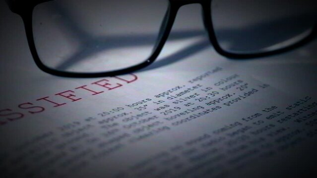 Classified document with pair of glasses in damaged film vintage style 