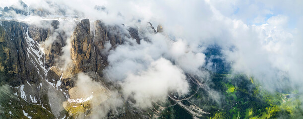 Breathtaking panorama of beautiful Alps mountains Dolomites, Val Gardena. Aerial drone shoot over clouds. northern Italy. Alpine nature scenery.  - 740917226