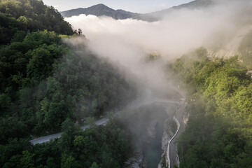 Foggy sunrise over Soca river near Kobarid in Slovenia, aerial drone view - 740918247