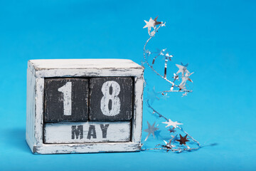 May 18 on calendar lying on blue background. Spring Astronomy Day.