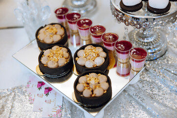 Almond cookies, sweet cakes for a wedding banquet. A delicious reception, a luxurious ceremony. Table with sweets and desserts. Delicious colorful French desserts on a plate or table. Candy bar.