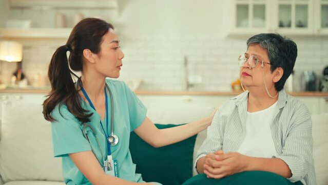young nurse explaining medical results in digital tablet laptop to senior couple Asian older woman talking to young female nurse doctor help patient education Care Retirement Volunteer CharityNursing