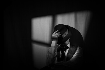 Film Noir style detective wearing a Fedora hat, tie and waistcoat in a dark, seedy office with a...