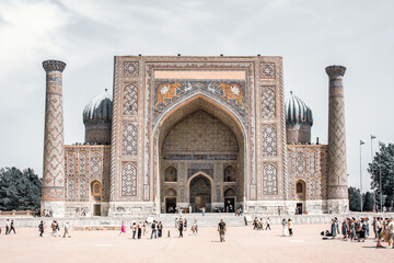 Sher-Dor Madrasah and crowd of tourists at the Registan square. A Unesco World Heritage Site, April...