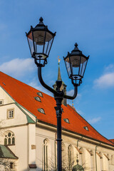 Fototapeta na wymiar Street lamp in front of the church in Celle in Germany.