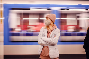 Woman Observing Fast-Moving Train at Subway Station