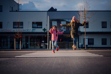 oyful Mother and Daughter Playing on Pedestrian Crossing