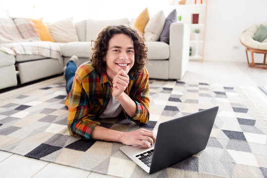 Photo of good mood funny guy dressed checkered shirt typing messages modern device indoors house home room