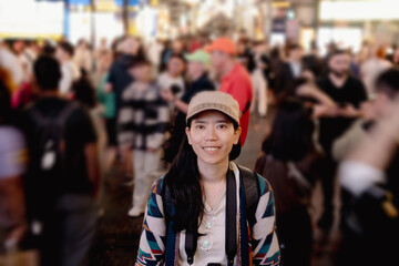 Asian woman friends shopping together at Shibuya district, Tokyo, Japan with crowd of people...