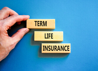 Term life insurance symbol. Concept words Term life insurance on beautiful wooden blocks. Beautiful blue table blue background. Doctor hand. Medical term life insurance concept. Copy space.
