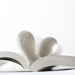 a book a heart on white background
