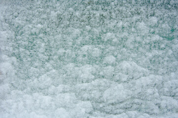 Fresh snow on a mosquito net. The net on the summer gazebo is covered with snow. Cold winter season.