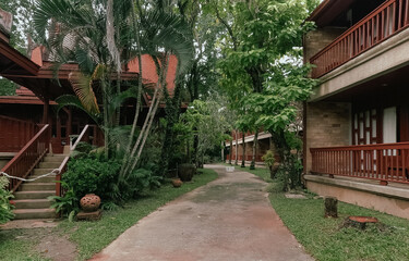 Traditional wooden thai houses with tranquil landscape