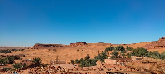 the remains of Ksar d'Ighzer, ruins of ancient stone and red clay houses, a village in the middle of the desert in the town of Timimoun, Algeria