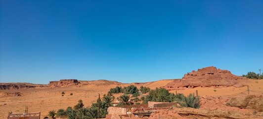 the remains of Ksar d'Ighzer, ruins of ancient stone and red clay houses, a village in the middle of the desert in the town of Timimoun, Algeria