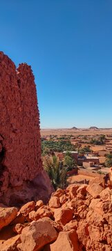 the remains of Ksar d'Ighzer, ruins of ancient stone and red clay houses, a village in the middle of the desert in the town of Timimoun, Algeria