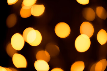 Bright yellow, gold lights, bokeh on black background