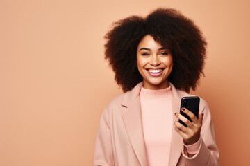 Happy African American woman with phone on Beige studio background