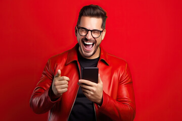 Man with phone on red studio background
