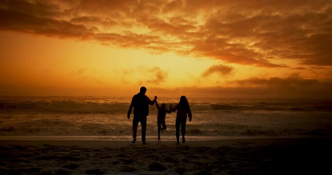 Sunset, beach and family holding hands, silhouette and vacation with adventure and happiness. Holiday, seaside and mother with father and child with parents and travel with care, support and ocean