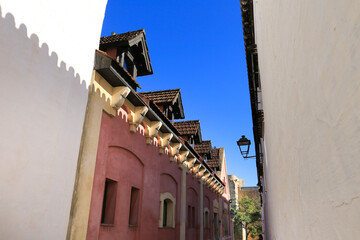 Fototapeta na wymiar Narrow street and beautiful facades in Sanlucar de Barrameda, Cadiz