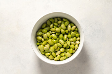 cooked edamame beans on bright background
