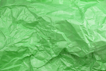 Fototapeta premium Сrumpled paper texture green. Texture of crumpled paper. Crumpled paper. Wrinkles paper.