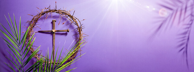 Lent -  Crown Of Thorns and Cross With Palm Leaves And Bloody Spikes For Penitence Concept With Abstract Sunlight