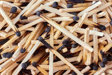 Background of scattered wooden burnt matches close-up. Top view with copy space