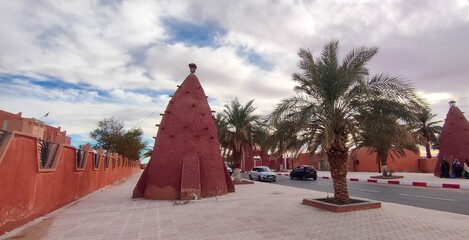 Street view of the beautiful architecture made of red clay in the city of Timimoun, Algeria
