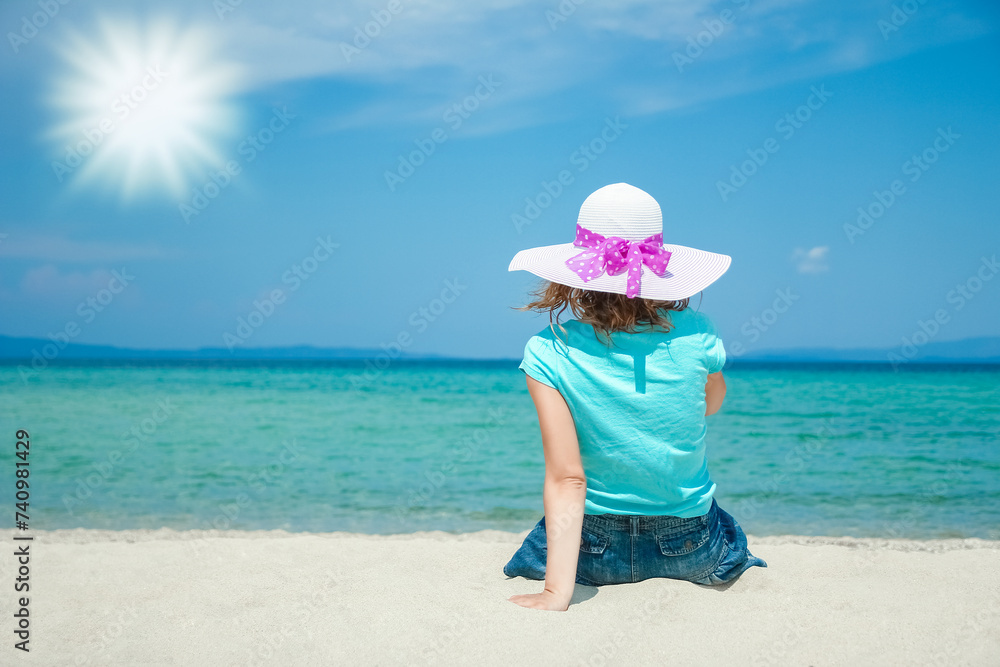 Wall mural happy girl at sea in greece on sand nature