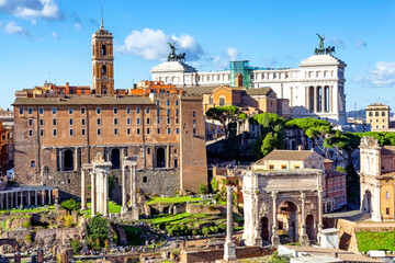 Ruins of the Roman Forum with the Capitolium and National Monument to Victor Emmanuel II in the background in Rome, Italy.