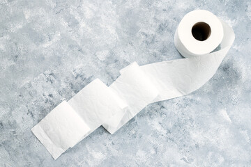 Roll of toilet paper on marble table background