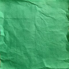 The image depicts a sheet of green paper with a noticeable crumpled texture, which creates a series of shadows and highlights across the surface, giving it a feeling of depth and tactile character.