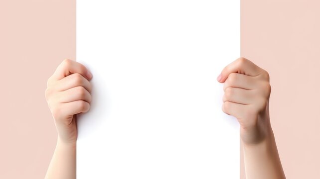 The image shows a close-up of a person's two hands with a pale complexion, gripping a vertical blank white sheet of paper, covering the center of the frame, with a plain, pastel-colored background tha