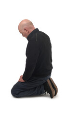 side view of a man kneeling on the floor in white background
