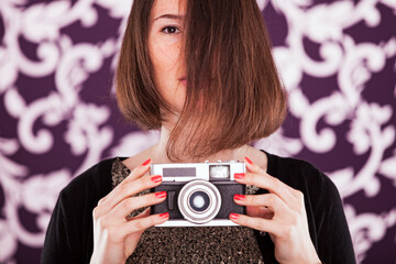 businesswoman holds a vintage camera - 741016206