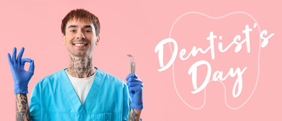 Male dentist with tools showing OK on pink background