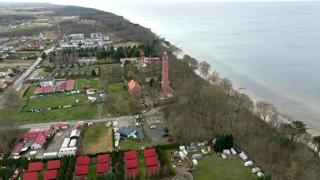 Lighthouse in Gąski by the Baltic Sea, in West Pomeranian Voivodeship, Poland. Winter landscape captured by drone.