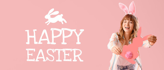 Young girl with Easter bunny ears and paper rabbit on pink background