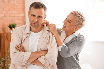 Mature man with his quarreling wife at home